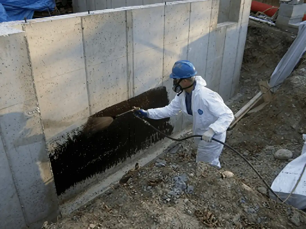 Professional waterproofing the exterior walls of the basement in Rockford, IL
