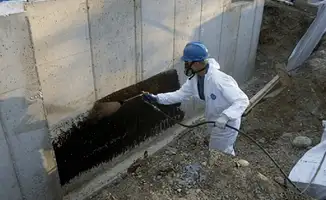 Professional waterproofing the exterior walls of the basement in Rockford, IL