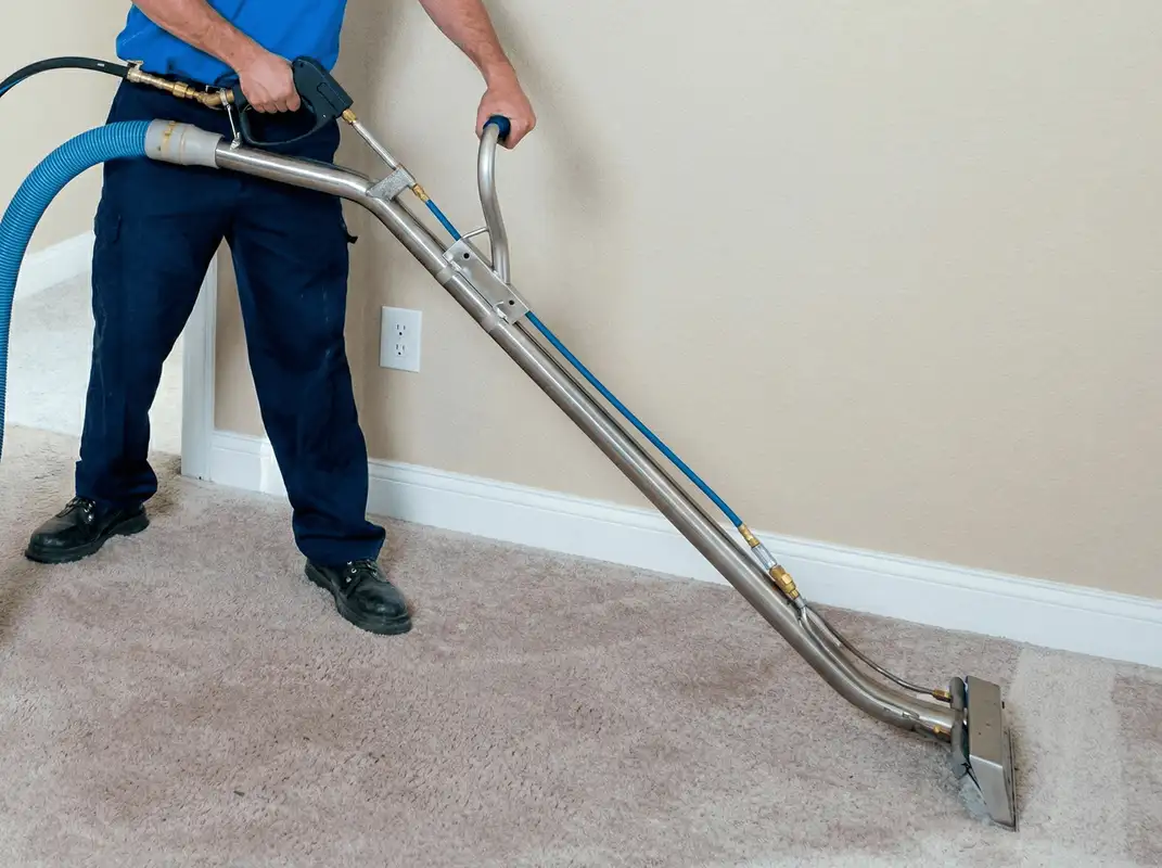 Professional operating a liquid removal machine on a carpeted floor in Rockford, IL